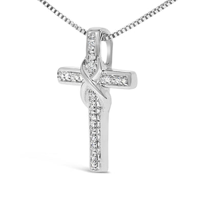 Front angle view of a white metal cross necklace pendant with white round gemstones in prong settings, featuring an intertwined design on a chain.