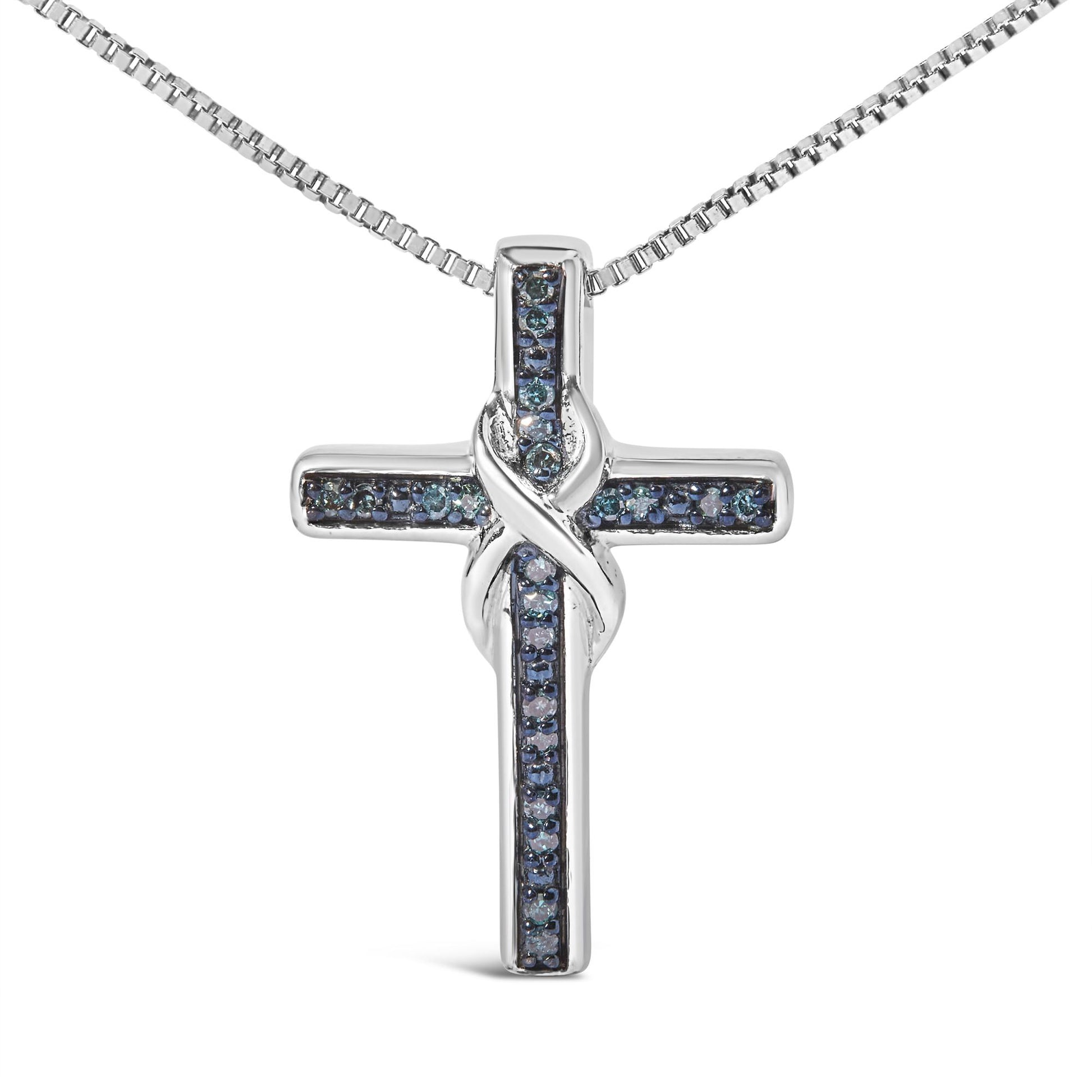 Front-facing shot of a white metal cross necklace pendant with blue round gemstones in prong settings arranged along the arms, featuring a twisted design where the vertical and horizontal bars intersect.