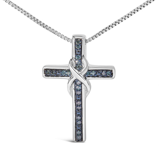 Front-facing shot of a white metal cross necklace pendant with blue round gemstones in prong settings arranged along the arms, featuring a twisted design where the vertical and horizontal bars intersect.