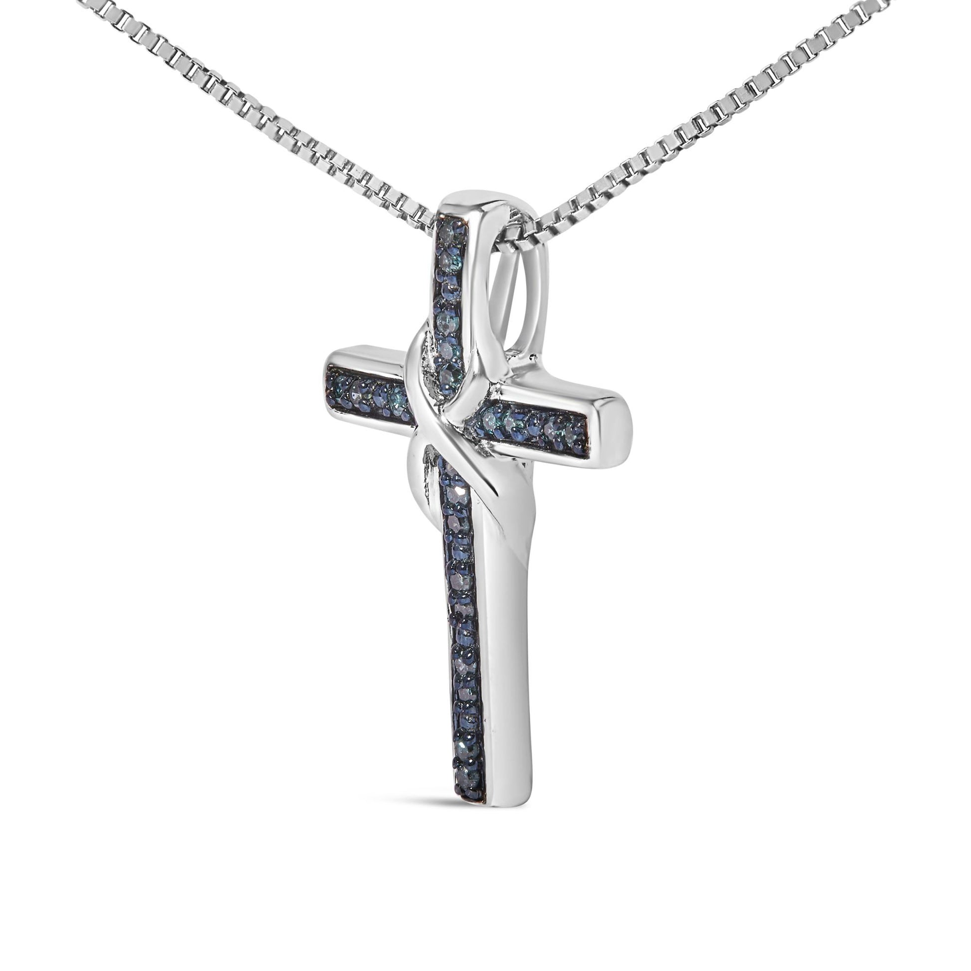 White metal necklace with a cross pendant featuring prong-set round blue gemstones, shown in a close-up angled front view.