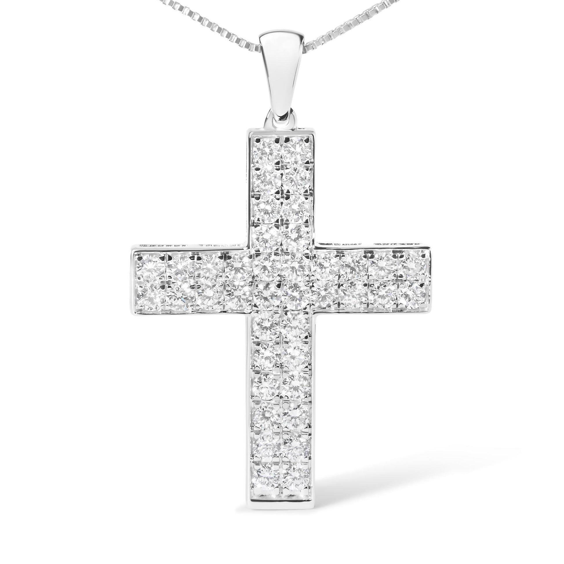 Front view of white metal cross-shaped necklace pendant with multiple round white gemstones in prong settings.