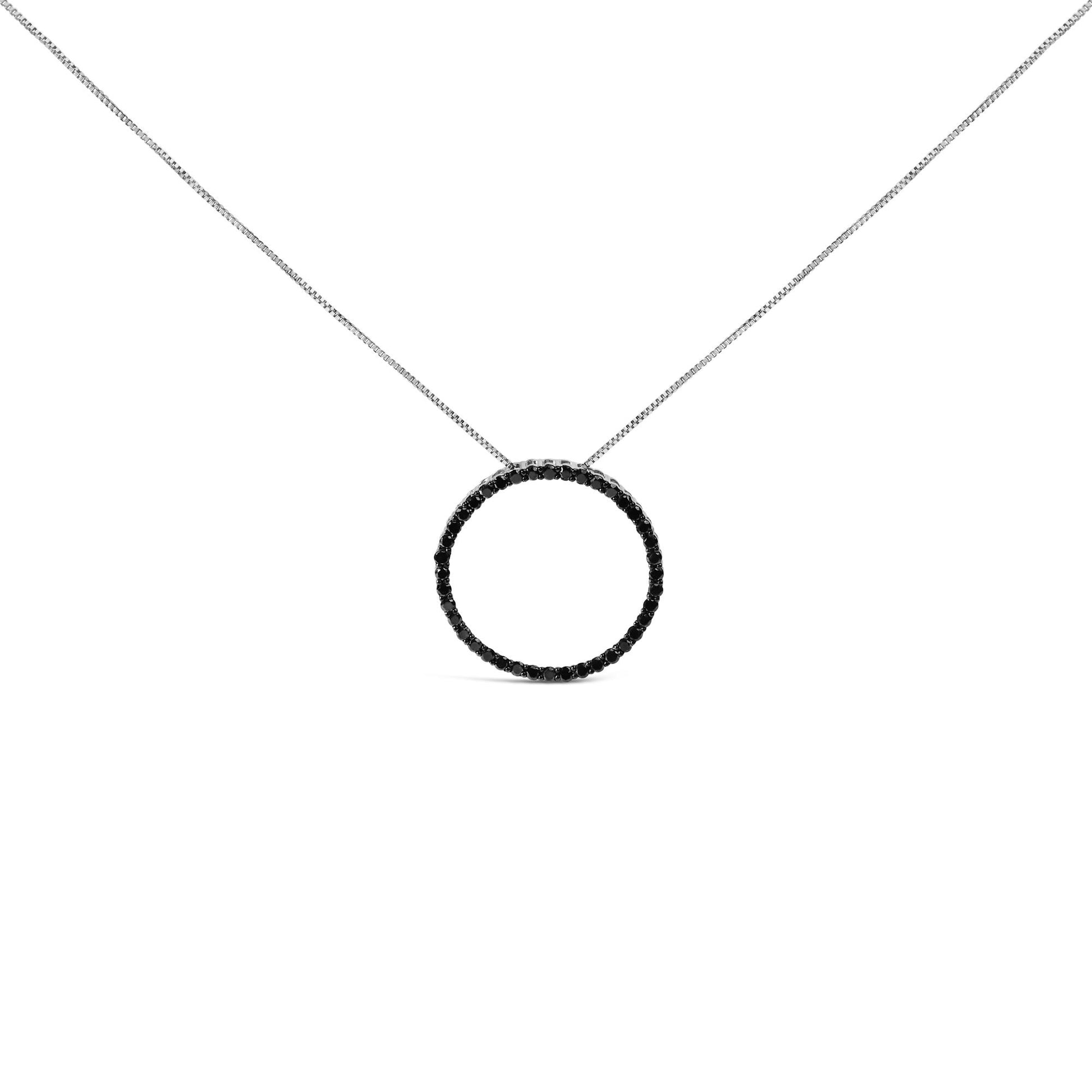 Front-facing shot of a white metal necklace with a circular pendant adorned with black round gemstones in a shared prong setting.