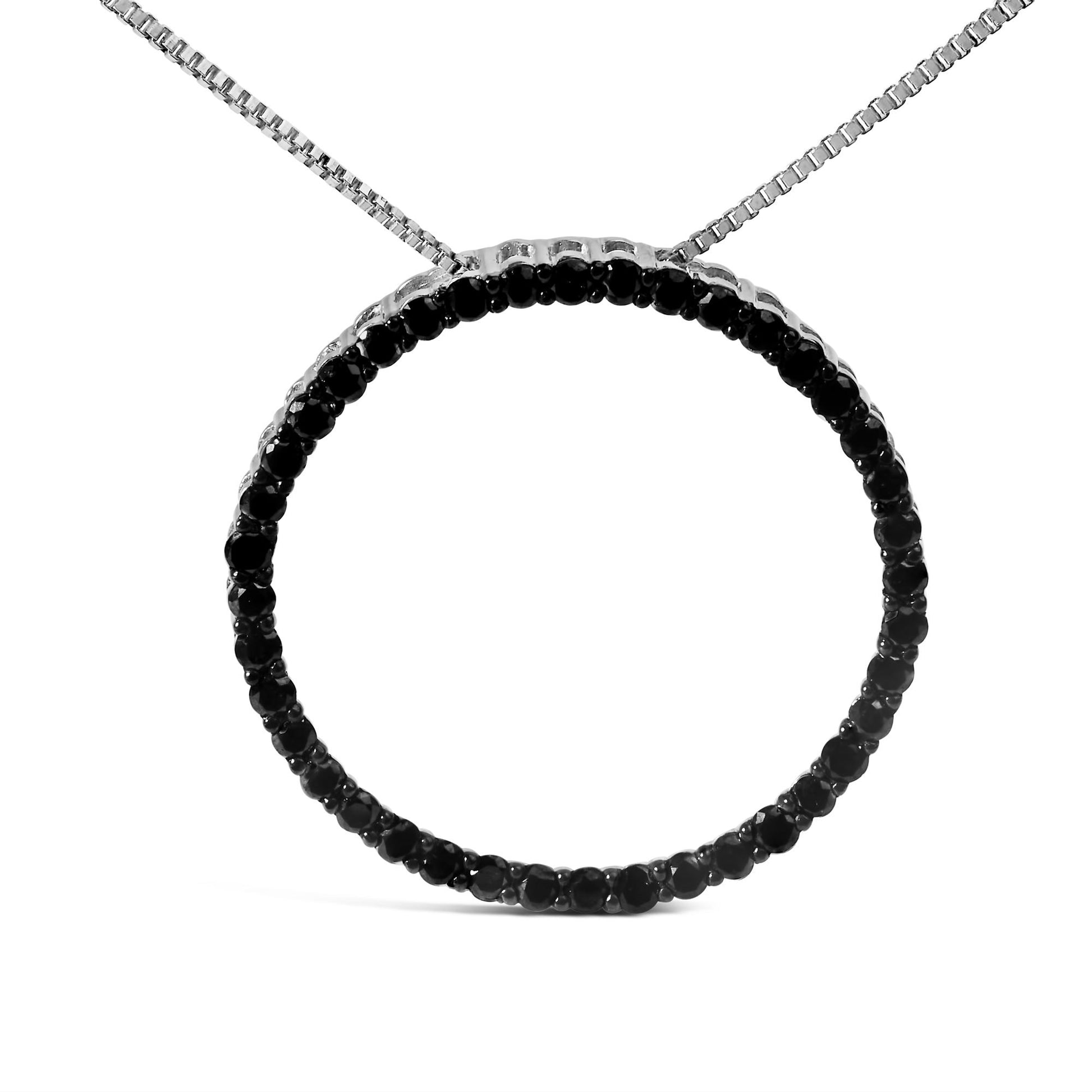 Close-up front view of a white metal circular necklace pendant set with round black gemstones in a shared prong setting.