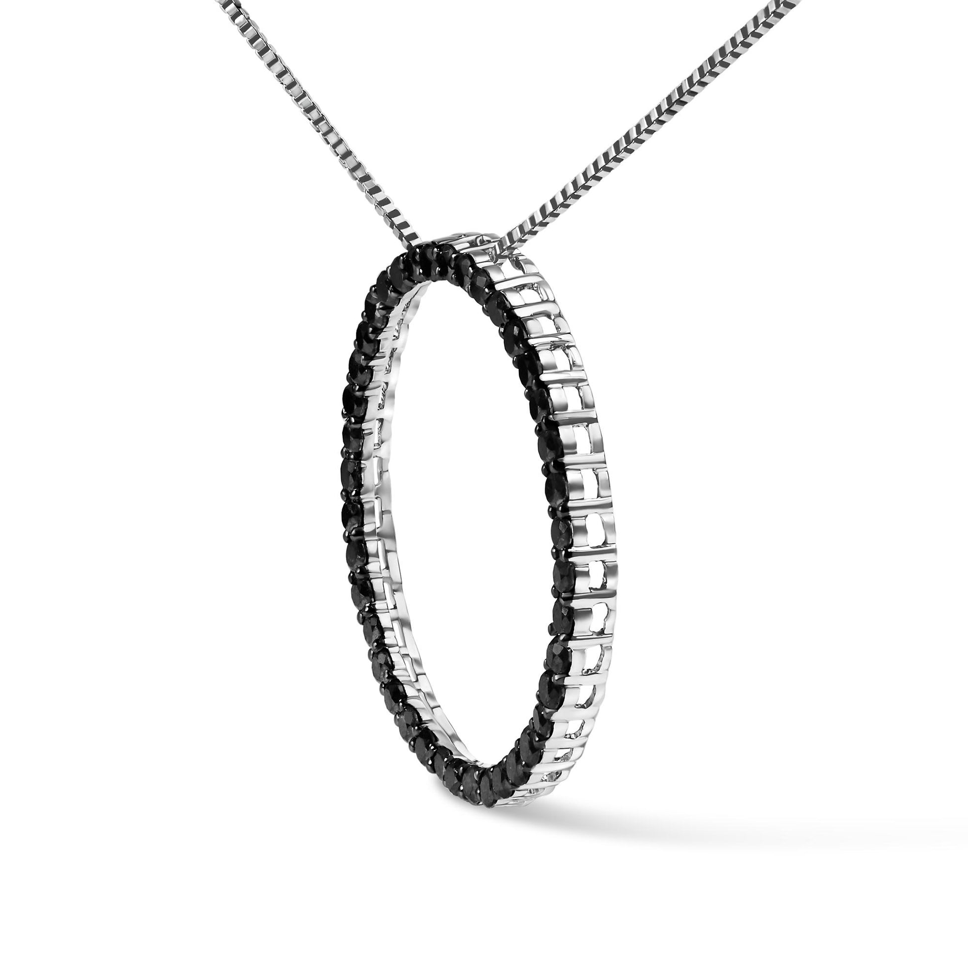 White metal necklace with a circular pendant set with round black gemstones in a shared prong setting, shown at an angled frontal view.