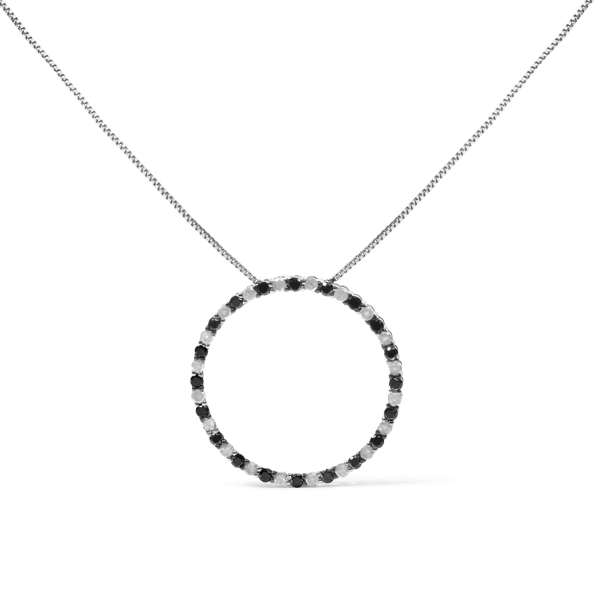 Front view of a white metal necklace with a circular pendant featuring alternating black and white round gemstones in prong settings.