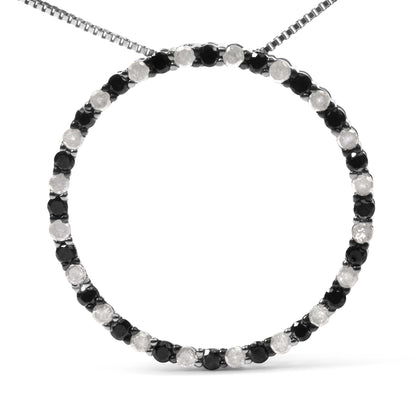 Front view of a white necklace with alternating round black and white gemstones in prong settings forming a circular pendant.