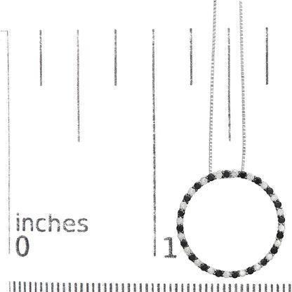 Close-up front view of a white metal circular necklace pendant with alternating black and white round prong-set gemstones, shown on a scale.