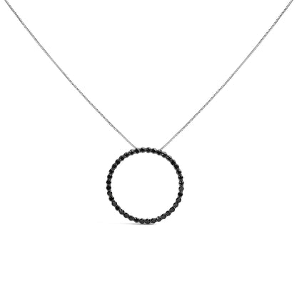 Front view of white necklace with circular pendant set with round black gemstones in shared prong setting on a white background.