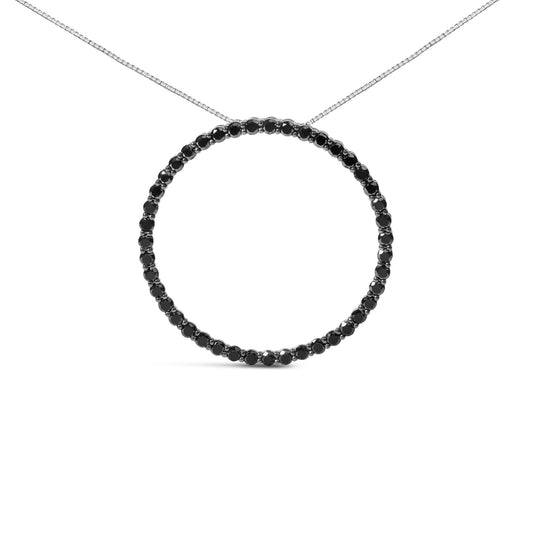 Front view of a white metal necklace with a circular pendant featuring round black gemstones in a shared prong setting.