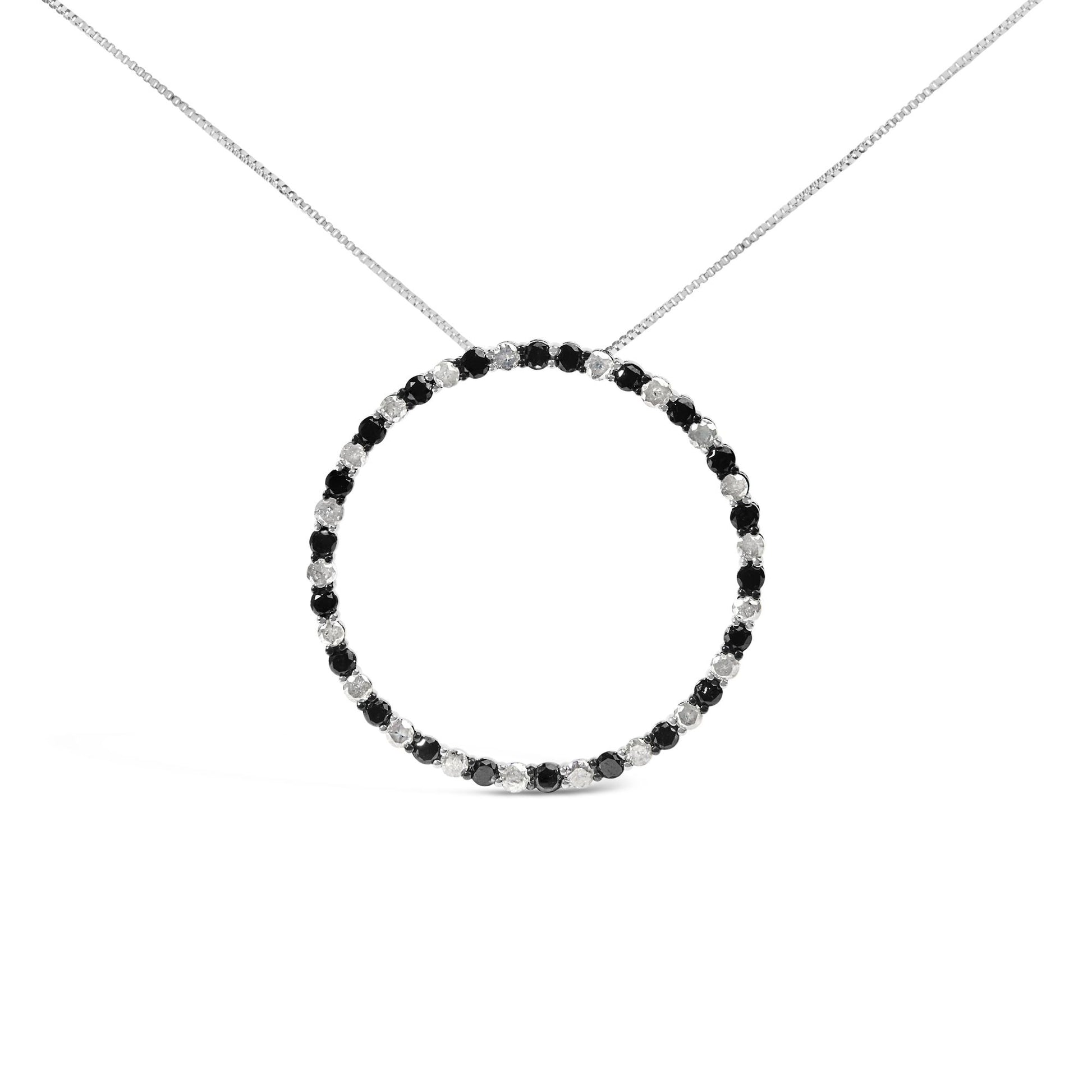 Front-facing shot of a white metal necklace with a circular pendant featuring alternating round black and white gemstones in prong settings.