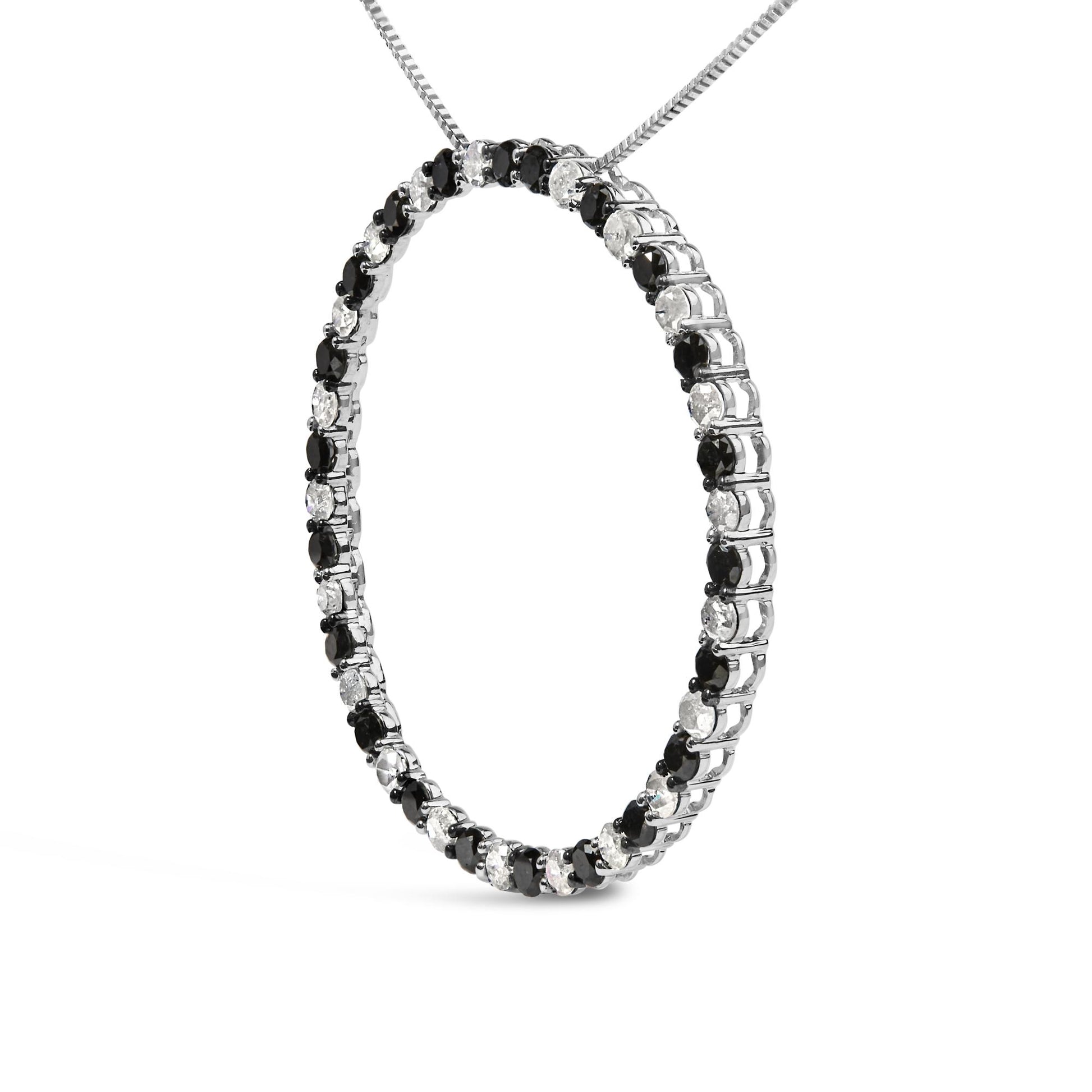 White metal necklace in a circular pendant shape set with alternating black and white round gemstones in prong settings, shown in a close-up angled shot.