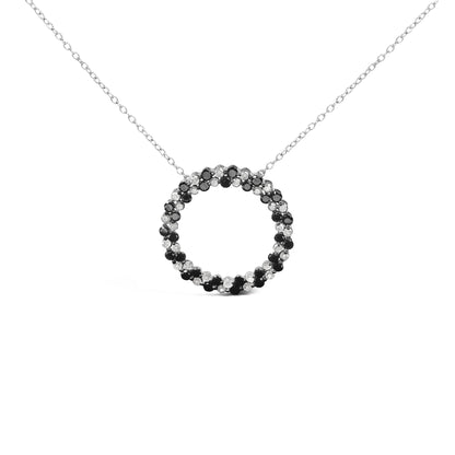 White metal necklace with circular pendant featuring alternating black and white round gemstones in prong settings, shown in a front-facing view.