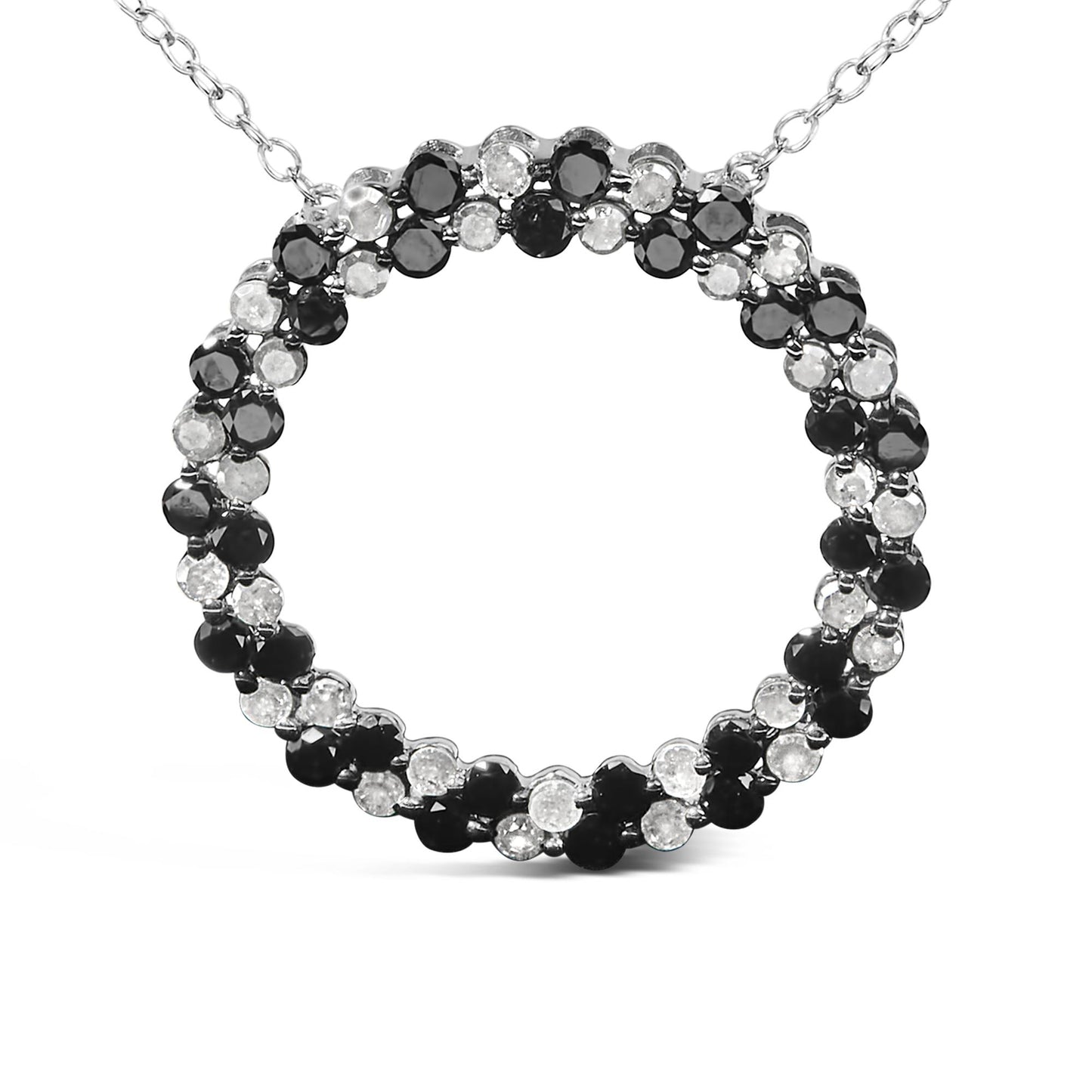 Close-up front view of a white metal necklace pendant featuring a circular design with alternating round black and white gemstones in prong settings.