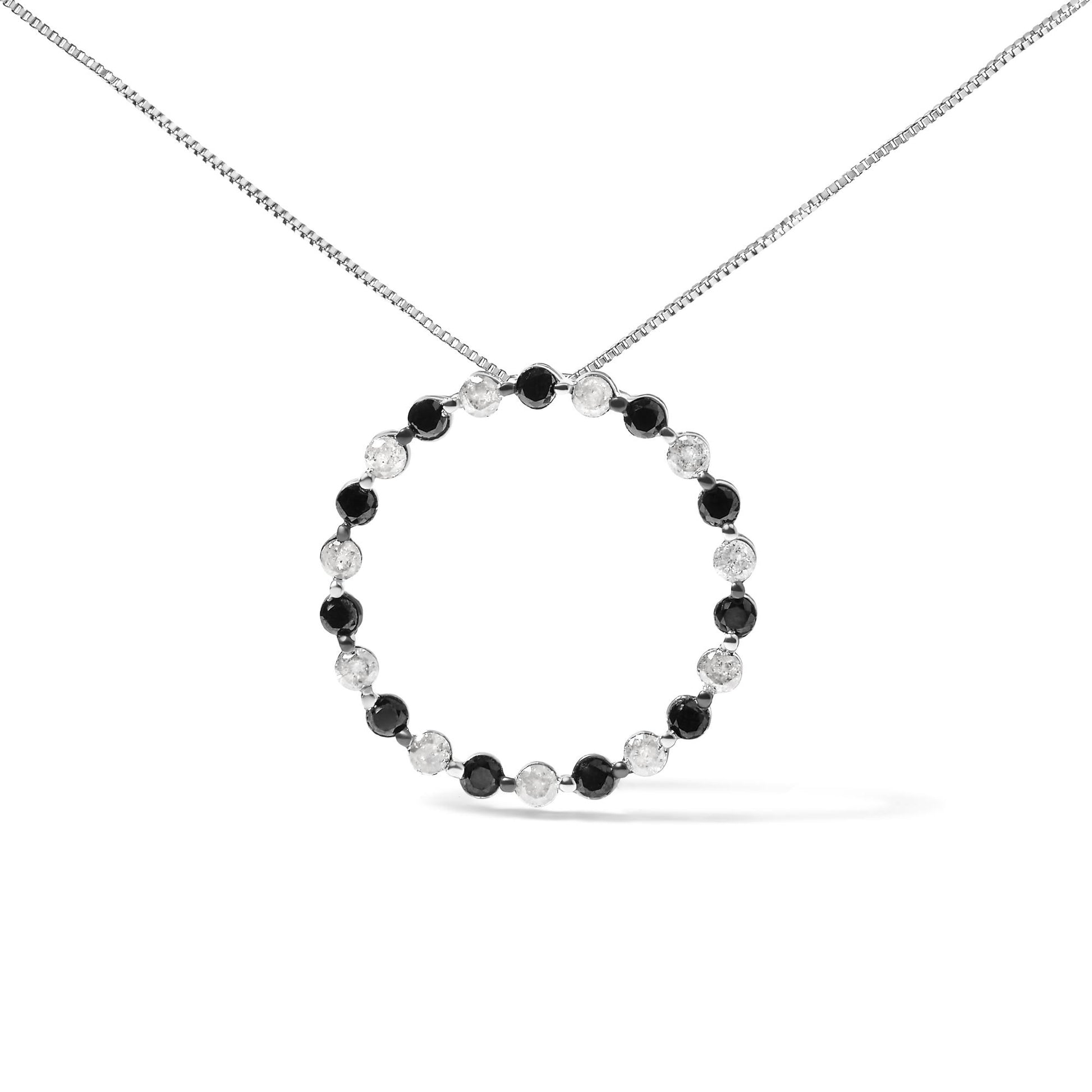 White metal necklace with a circular pendant featuring alternating round black and white gemstones in prong settings, shown from a front angle on a white background.