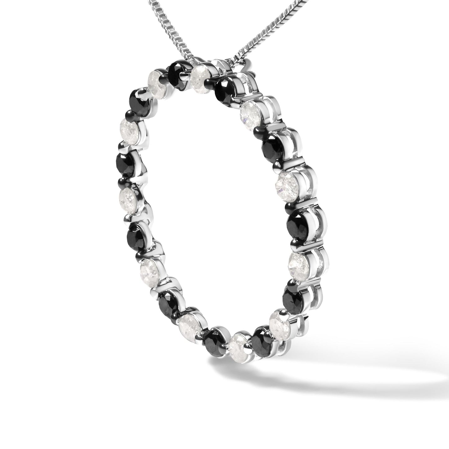 Close-up angled shot of a white metal circular necklace pendant featuring alternating round white and black gemstones in prong settings, suspended from a white metal chain.