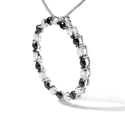 Close-up angled shot of a white metal circular necklace pendant featuring alternating round white and black gemstones in prong settings, suspended from a white metal chain.