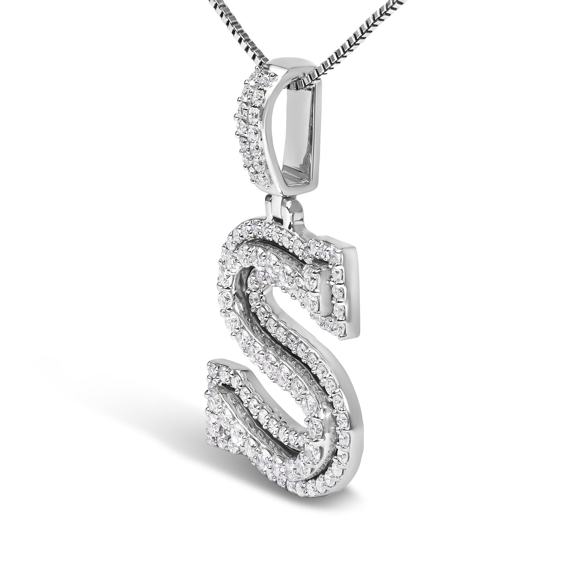 Close-up angled view of a white metal necklace pendant in the shape of the letter 'S,' adorned with multiple round white gemstones in prong settings along the edges and interior curves.