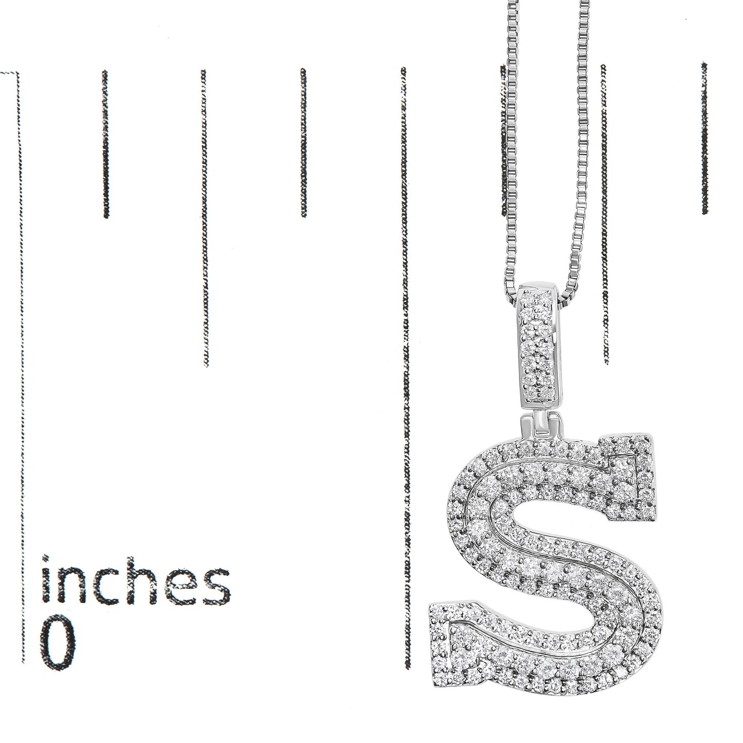 Close-up front angle of a white metal necklace with an 'S'-shaped pendant encrusted with round white gemstones, shown on a scale.