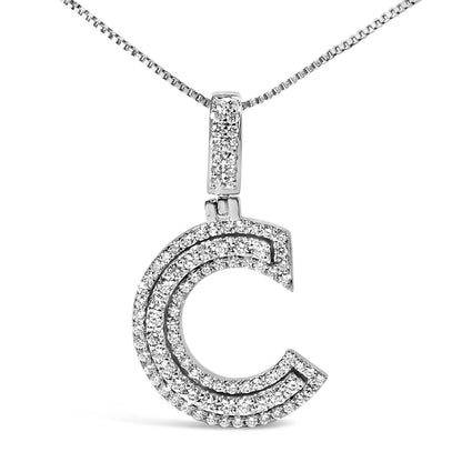 Close-up front view of a white metal necklace pendant shaped like a stylized letter 'C' adorned with multiple rows of small round white gemstones in prong settings, hanging from a white metal chain.