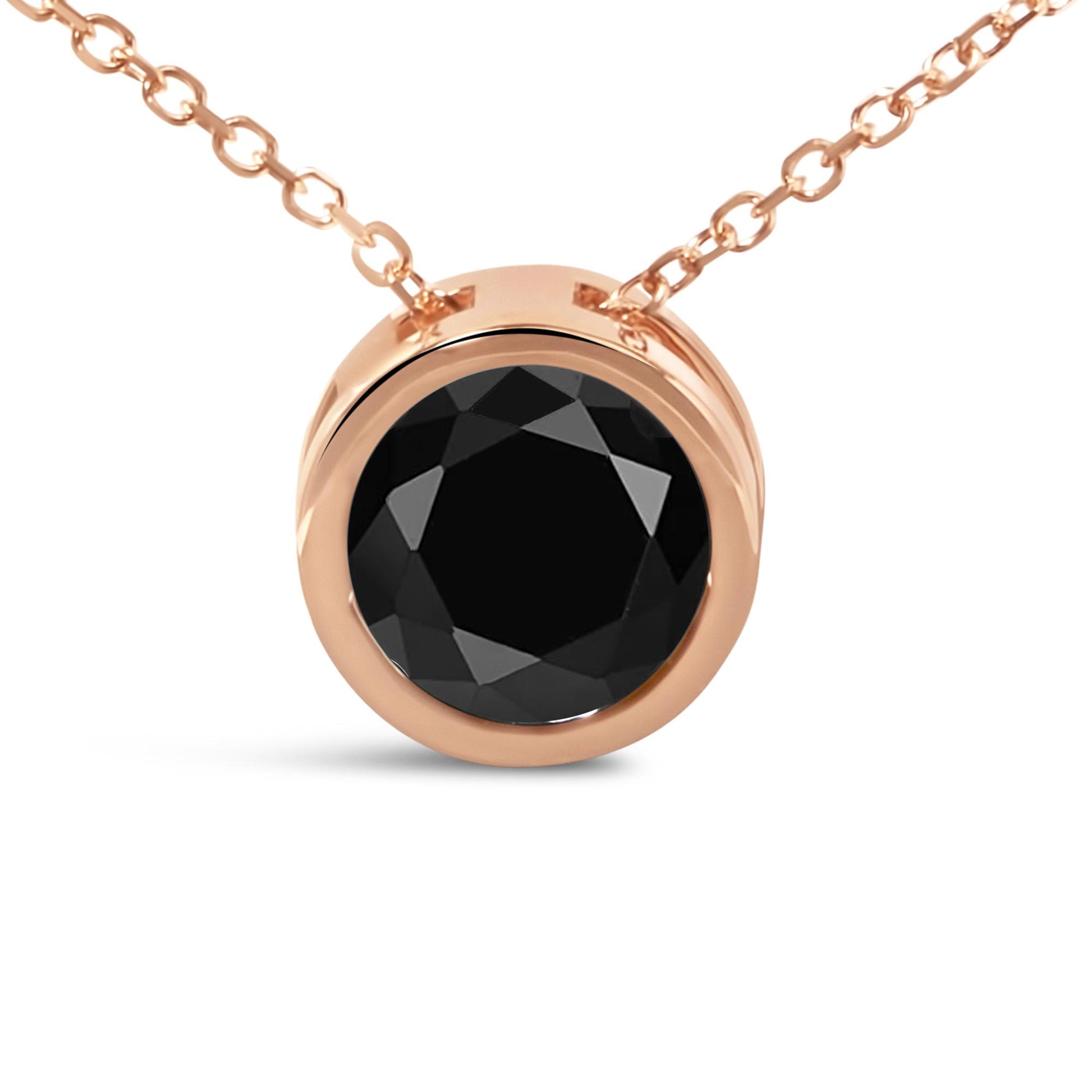 Close-up front angle of a rose metal necklace with a round black gemstone in bezel setting.