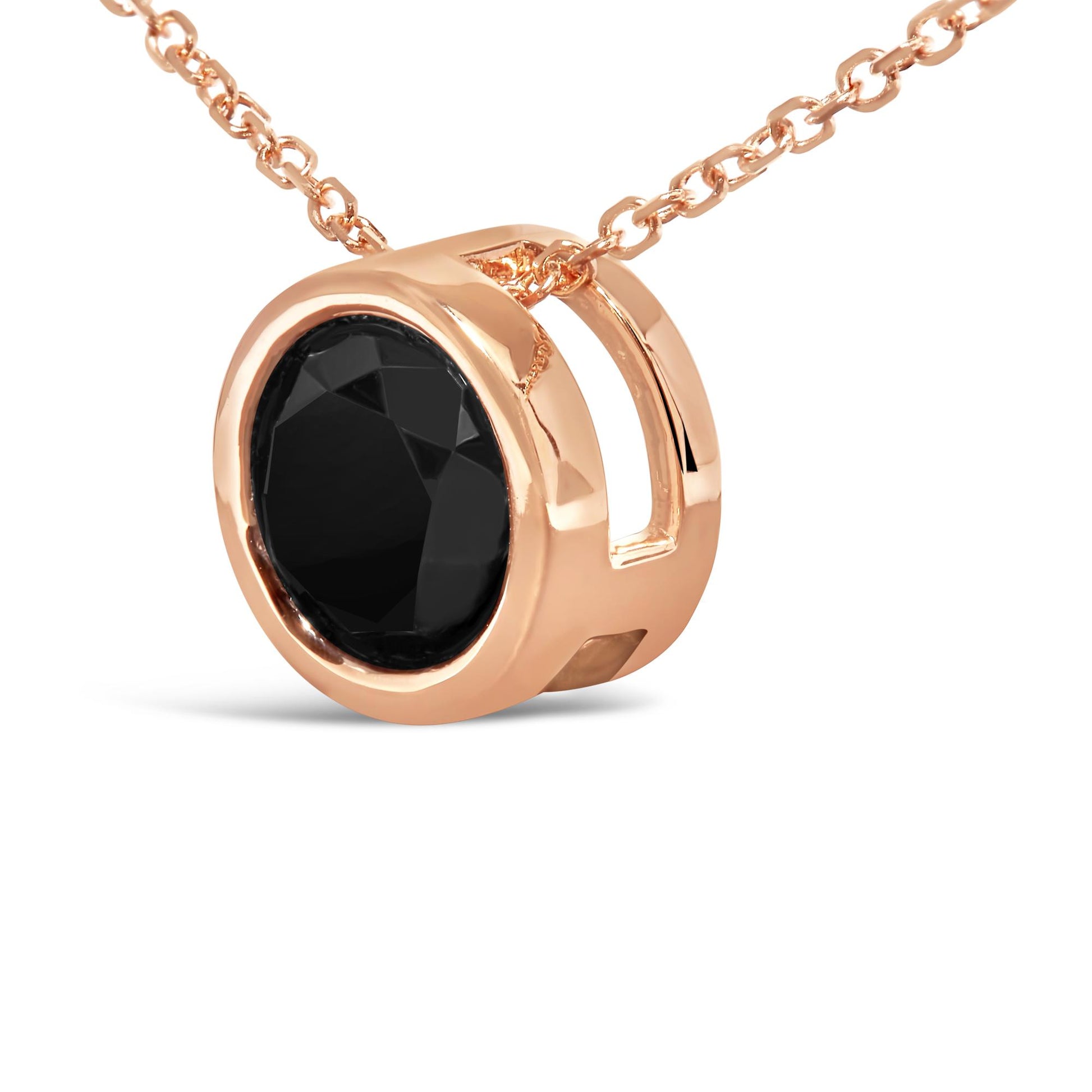 Close-up angled view of a rose-colored necklace pendant with a round black gemstone in a bezel setting on a matching chain.