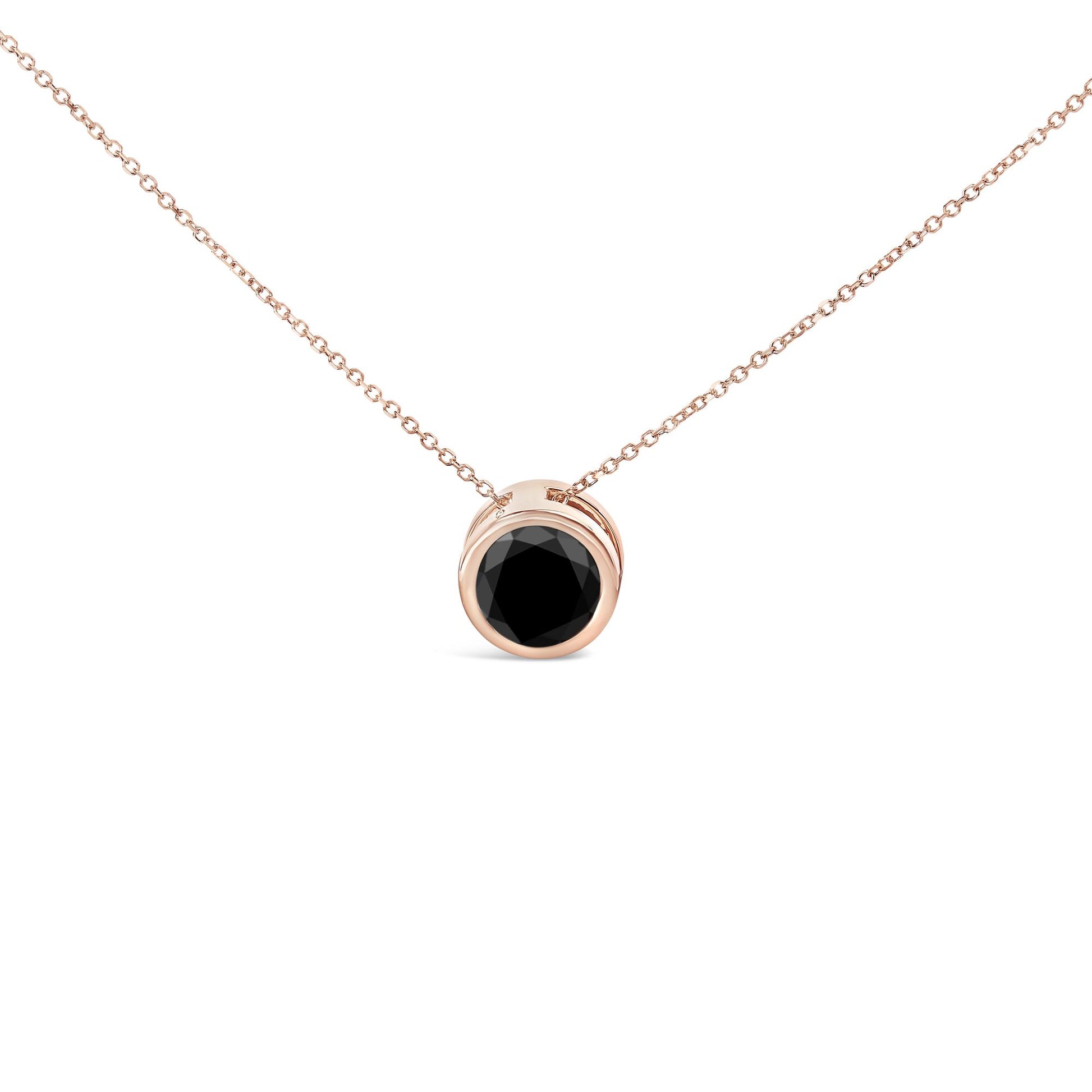 Front angle close-up of a rose metal necklace with a pendant featuring a round black gemstone in a bezel setting.