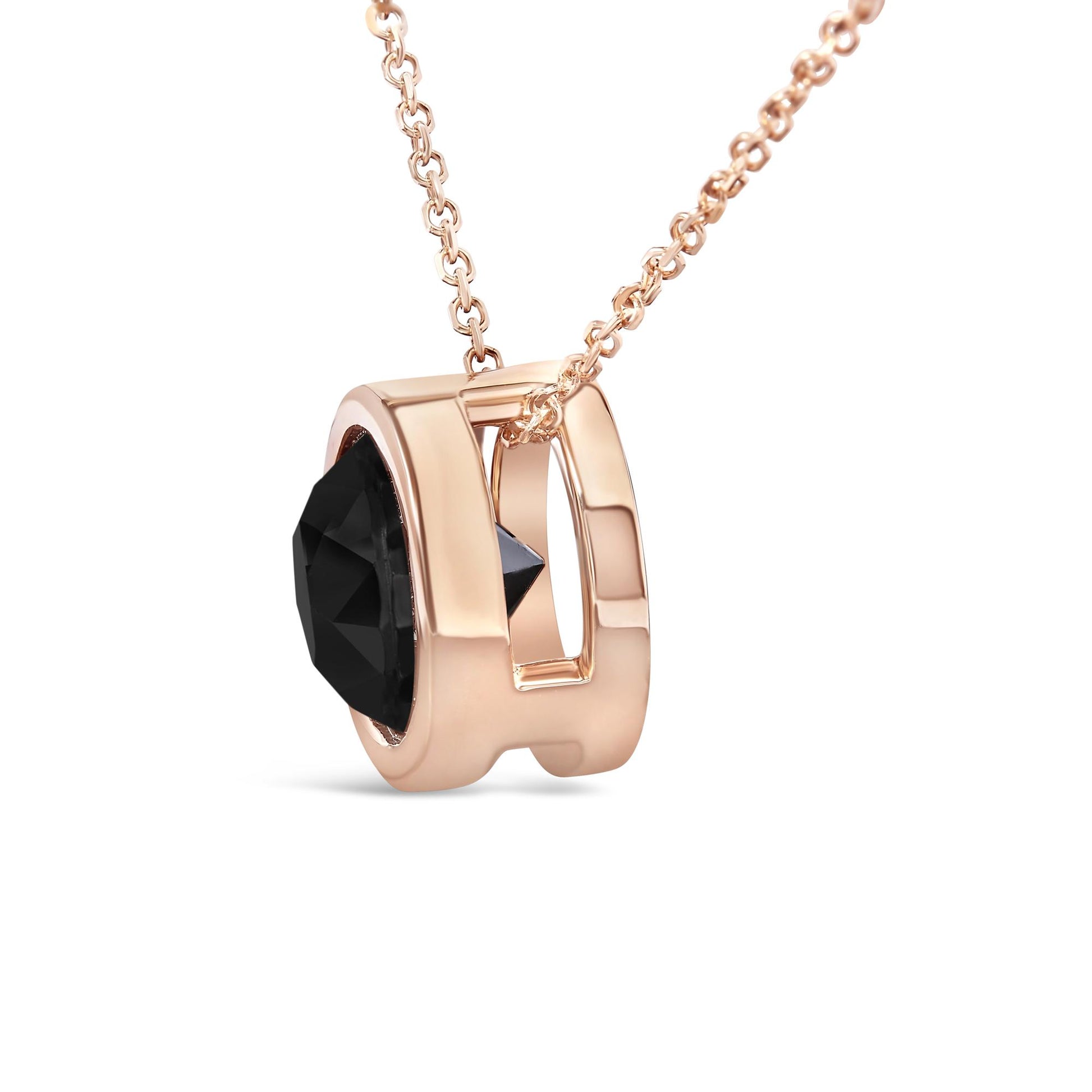 Rose metal necklace with a round black gemstone in bezel setting, shown in a close-up side angle.