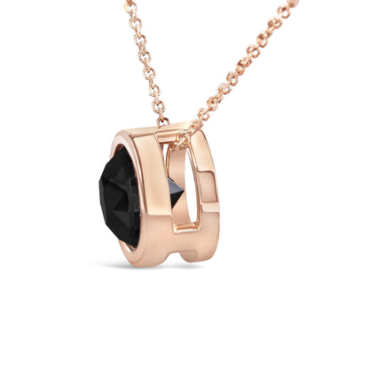 Rose metal necklace with a round black gemstone in bezel setting, shown in a close-up side angle.
