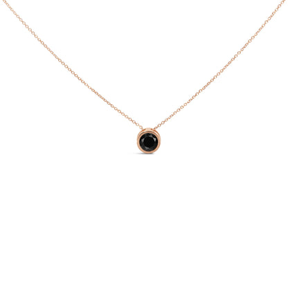 Front view of a rose metal necklace with a round black gemstone in a bezel setting pendant.