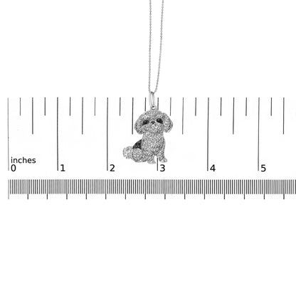 Front-facing shot of a white metal dog-shaped necklace pendant with micro-pave set round black and white gemstones, displayed on a ruler for size reference.