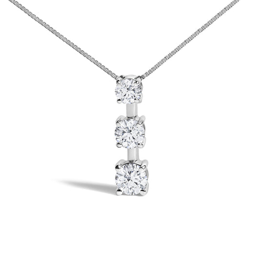 Close-up front view of a white metal necklace featuring a vertical pendant with three round white gemstones, two with prong settings and one with a miracle setting, shown on a plain white background.