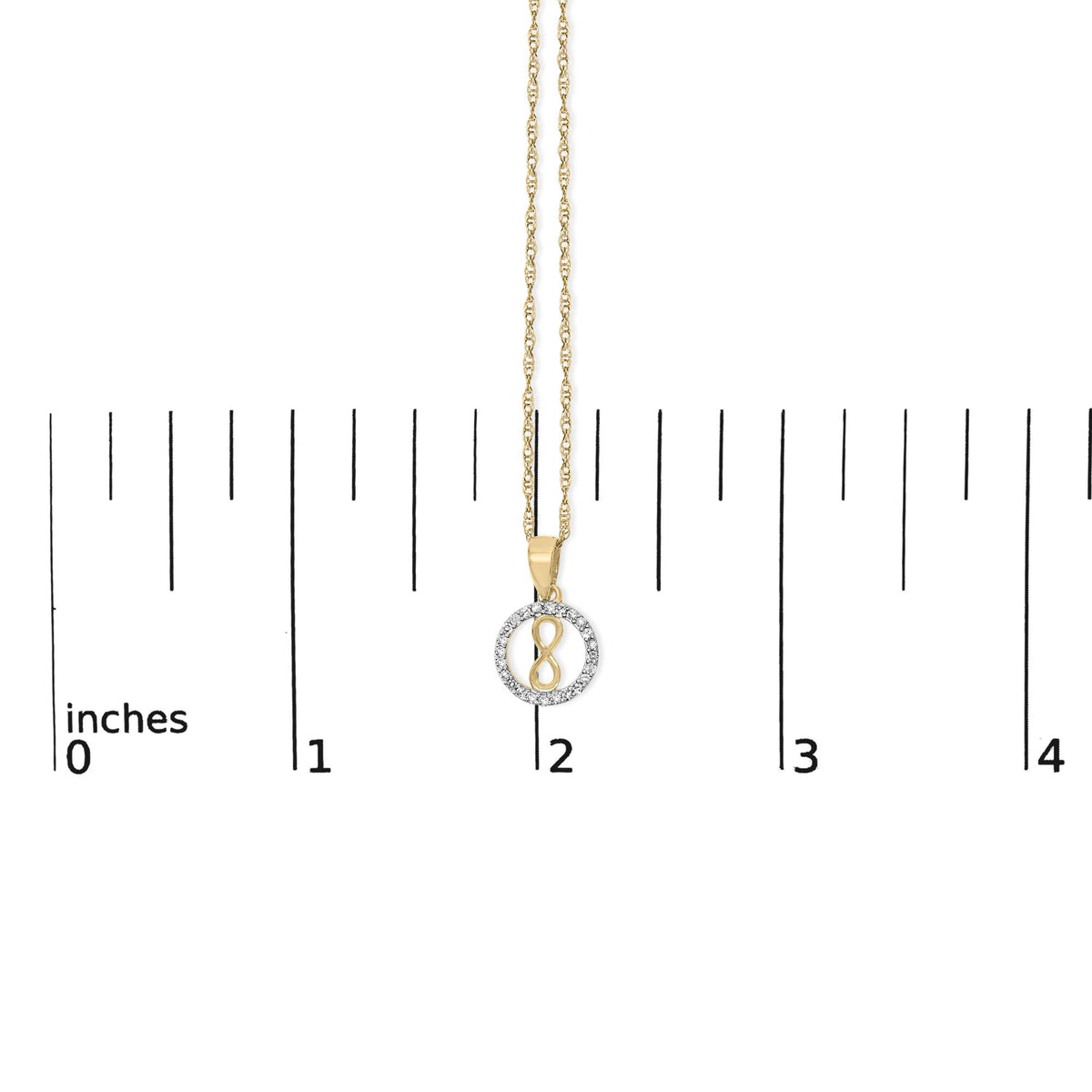 Close-up front view of a yellow metal necklace pendant with an infinity symbol surrounded by a circle of white gemstones, shown on a scale.