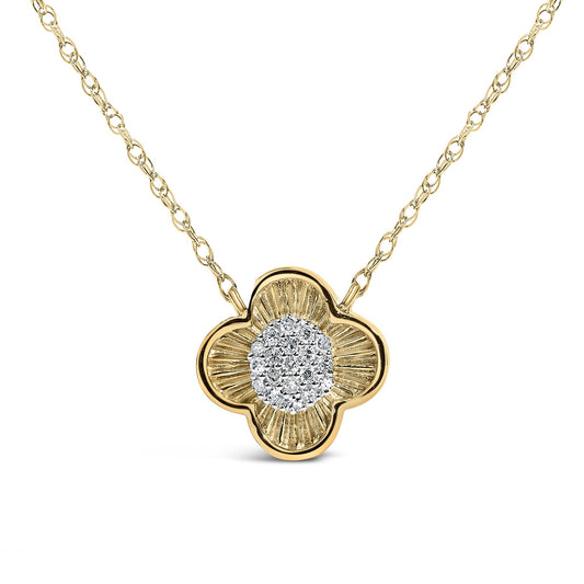 Close-up angled shot of a yellow metal necklace with a flower-shaped pendant. The pendant features a center cluster of white round gemstones in prong settings, surrounded by textured yellow metal petals. The necklace chain is visible and composed of interlocking links.