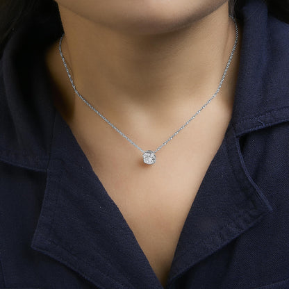 Necklace with a white metal chain and cluster pendant featuring multiple round white gemstones in prong settings, shown worn on a model from a front angle.