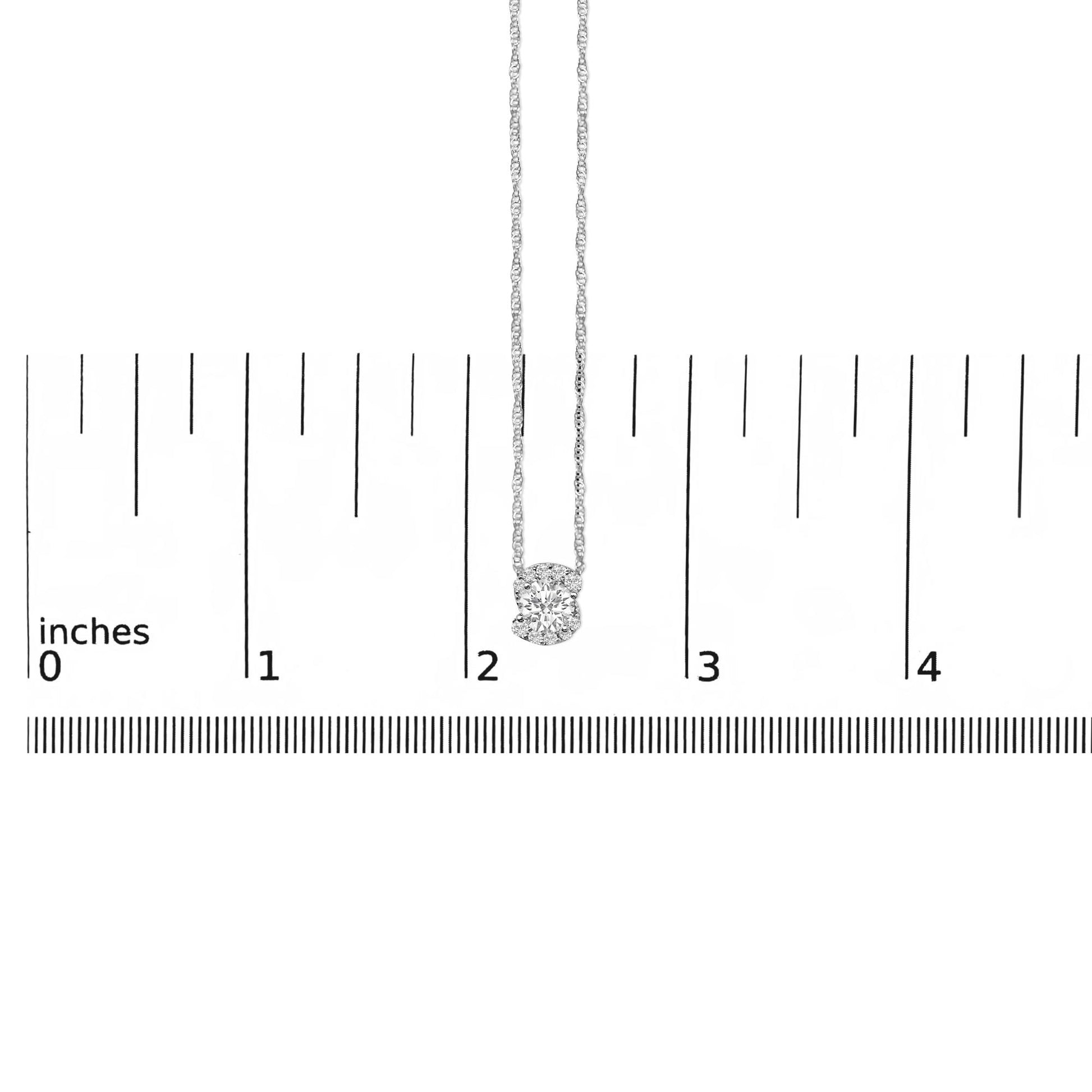 White metal necklace with a round white gemstone pendant shown hanging against a ruler for scale, photographed from the front.