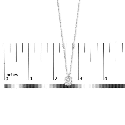 Necklace with a pendant featuring multiple round white gemstones in prong settings, shown on a scale from a front angle.