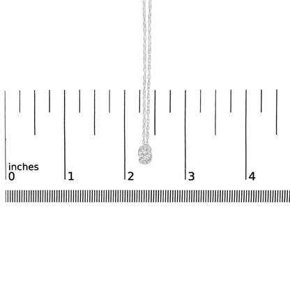 White necklace with pendant featuring four round white gemstones in prong setting, shown hanging on a ruler scale from a front angle.