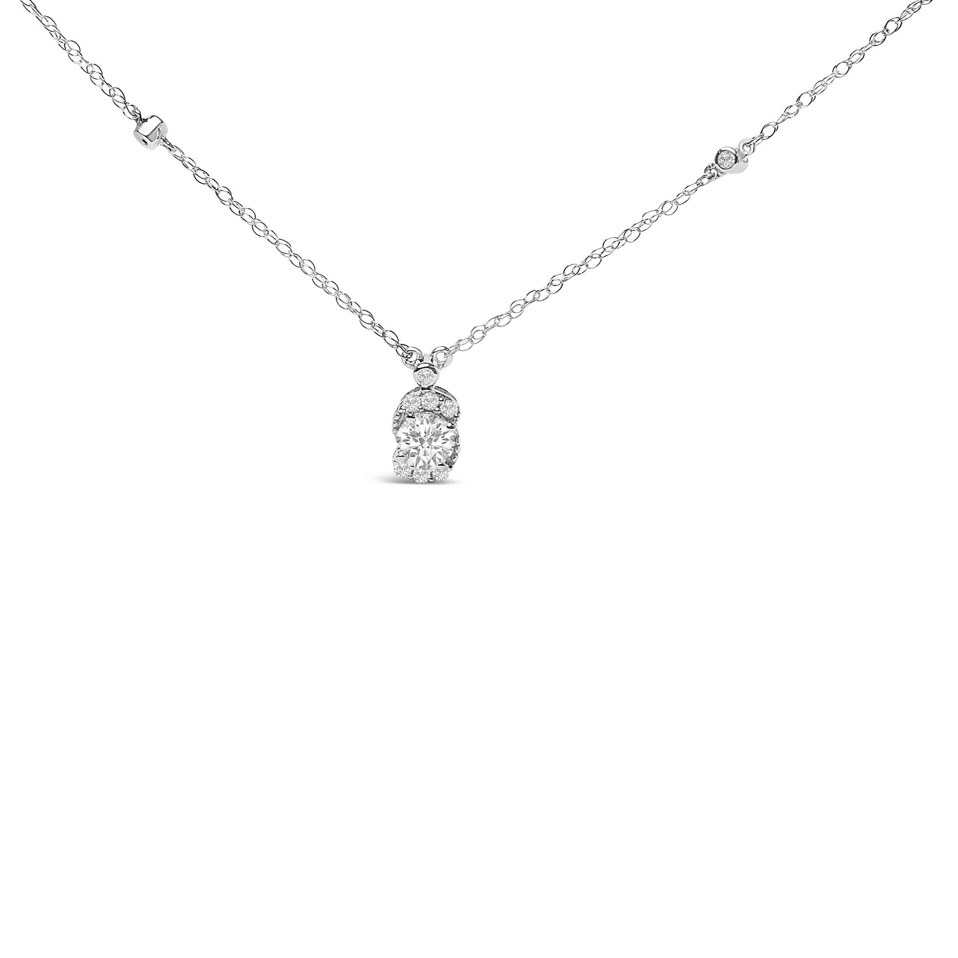 Close-up front view of a white metal necklace with a pendant featuring a large round white gemstone surrounded by smaller white gemstones, shown against a white background.