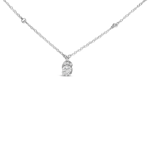Close-up front view of a white metal necklace with a pendant featuring a large round white gemstone surrounded by smaller white gemstones, shown against a white background.