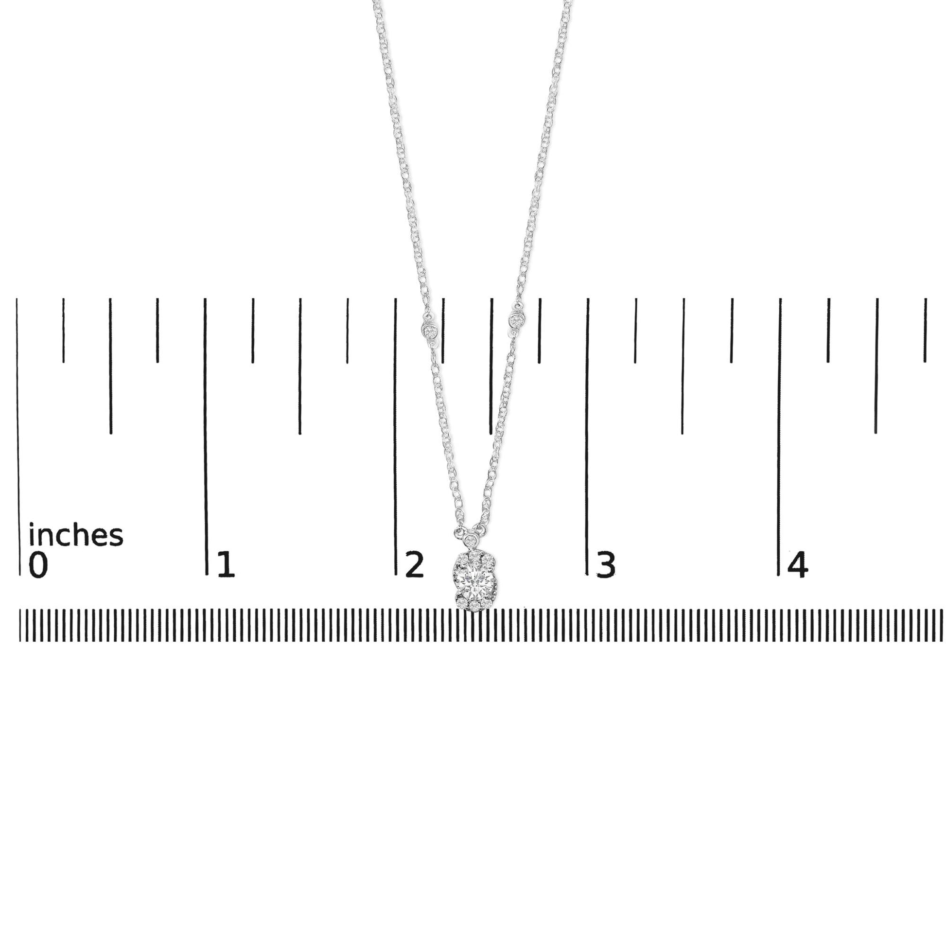 White necklace with a pendant featuring one large white gemstone surrounded by smaller white gemstones, shown on a scale with the image taken from a front angle.