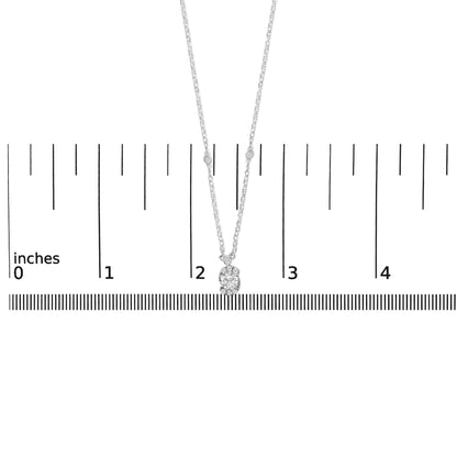 White necklace with a pendant featuring one large white gemstone surrounded by smaller white gemstones, shown on a scale with the image taken from a front angle.