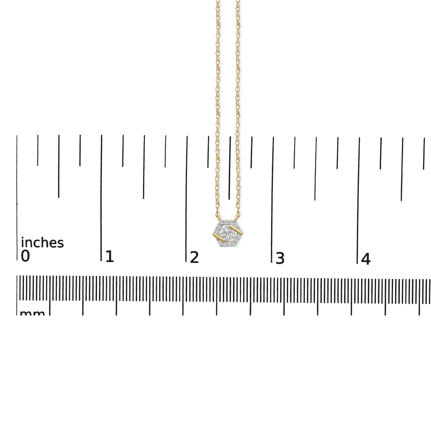 Yellow metal necklace with a hexagonal-shaped pendant featuring one large round white gemstone and surrounding smaller round white gemstones, shown on a ruler scale from a top-down angle.
