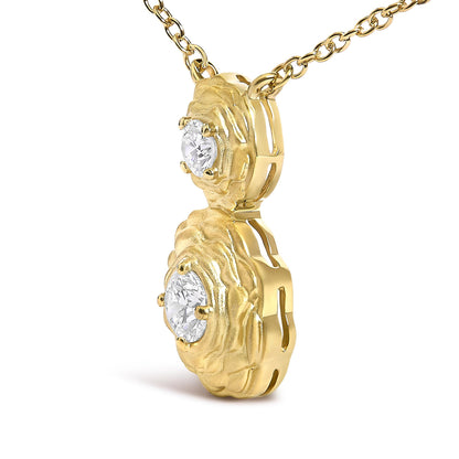 Close-up side angle of a yellow metal necklace pendant featuring two round white gemstones in 4-prong settings with textured surrounds.