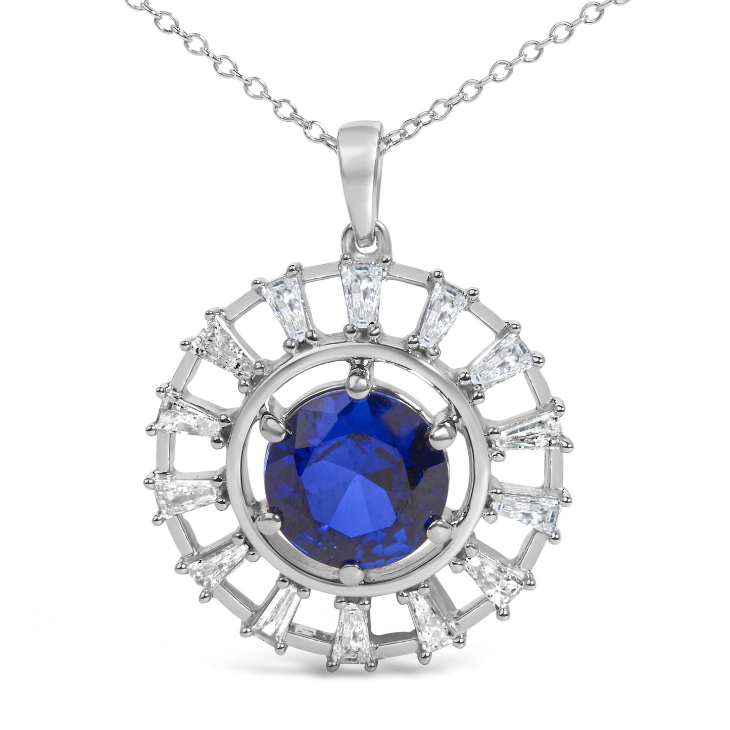 Close-up front view of a white metal necklace pendant featuring a large round blue gemstone center surrounded by a circular arrangement of white baguette-shaped gemstones in prong settings, shown on a plain white background.