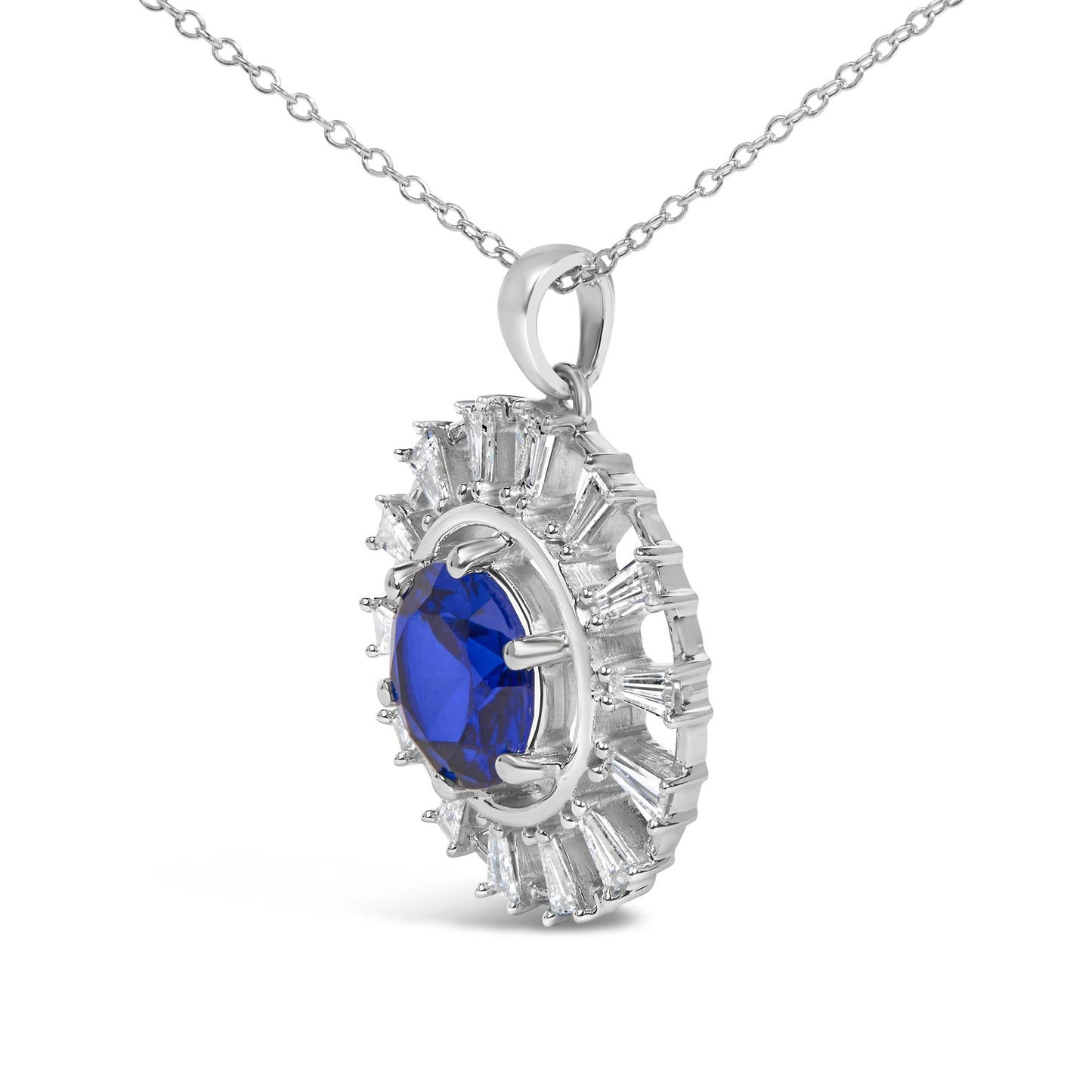 Close-up front angle of a white necklace pendant featuring a large blue gemstone center surrounded by white baguette-shaped gemstones in prong settings, shown on a white background.