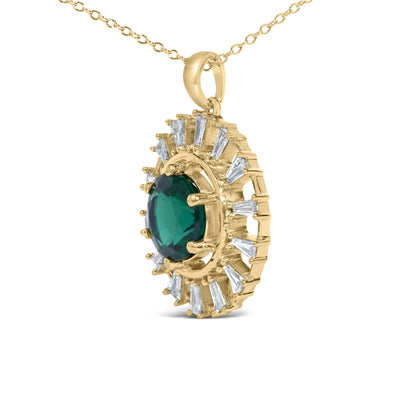 Close-up front angle of yellow metal necklace pendant featuring a large green round gemstone center surrounded by white baguette-shaped gemstones in prong settings.
