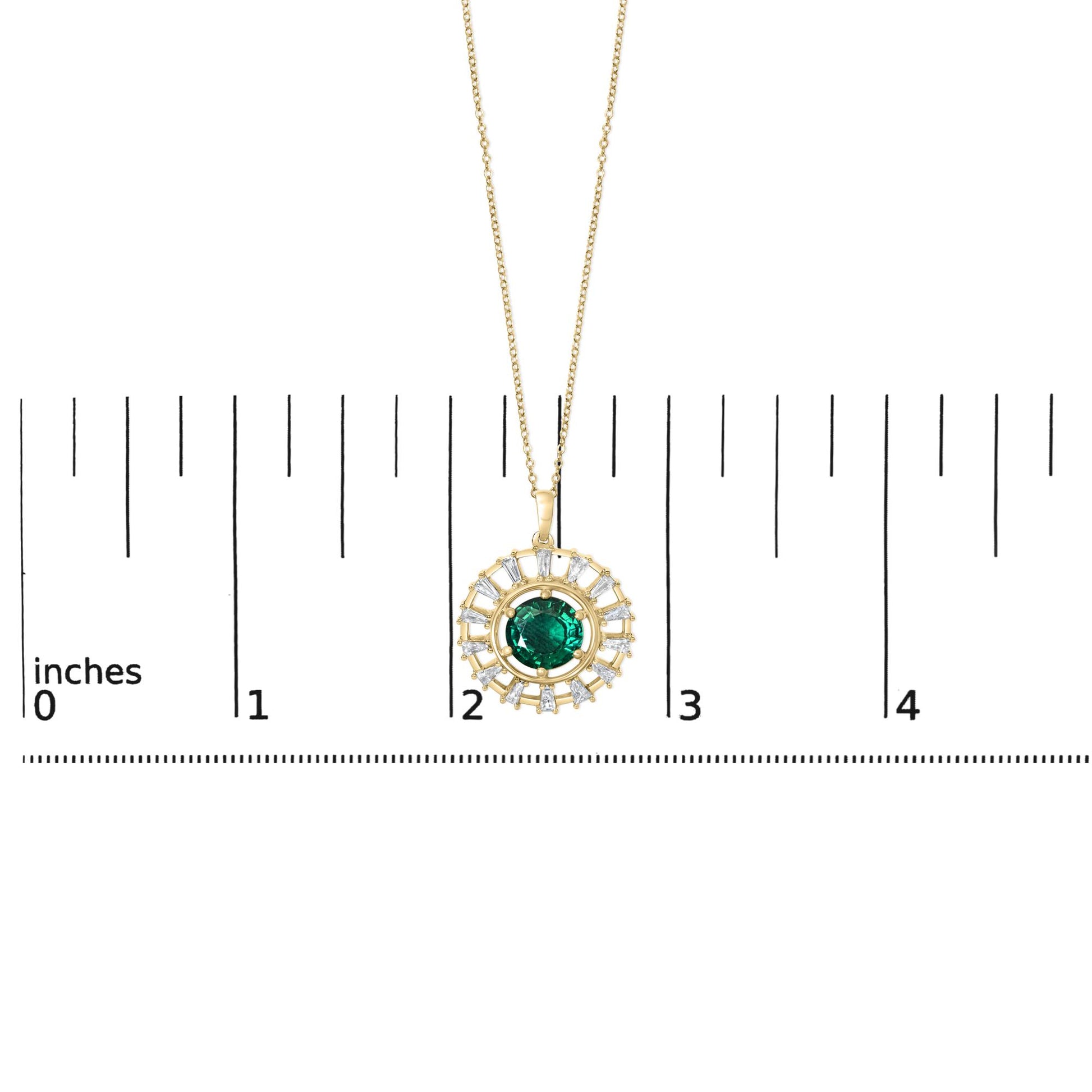 Yellow metal necklace with a round green gemstone pendant encircled by white baguette-shaped gemstones, shown on a scale, top-down angle.