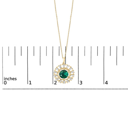 Yellow metal necklace with a round green gemstone pendant encircled by white baguette-shaped gemstones, shown on a scale, top-down angle.