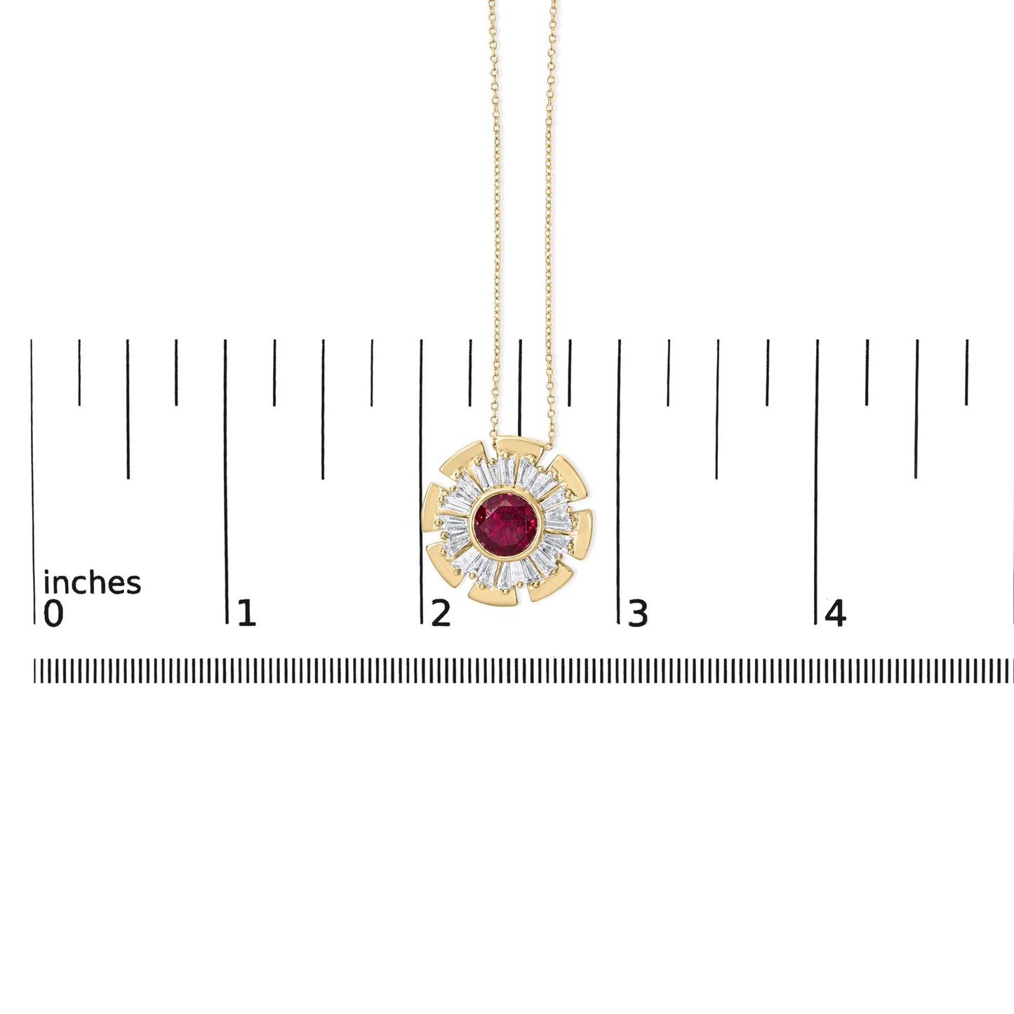 Close-up front view of a yellow metal necklace pendant with a round red gemstone bezel set in the center, surrounded by prong-set white baguette-shaped gemstones in a circular pattern, shown on a scale.