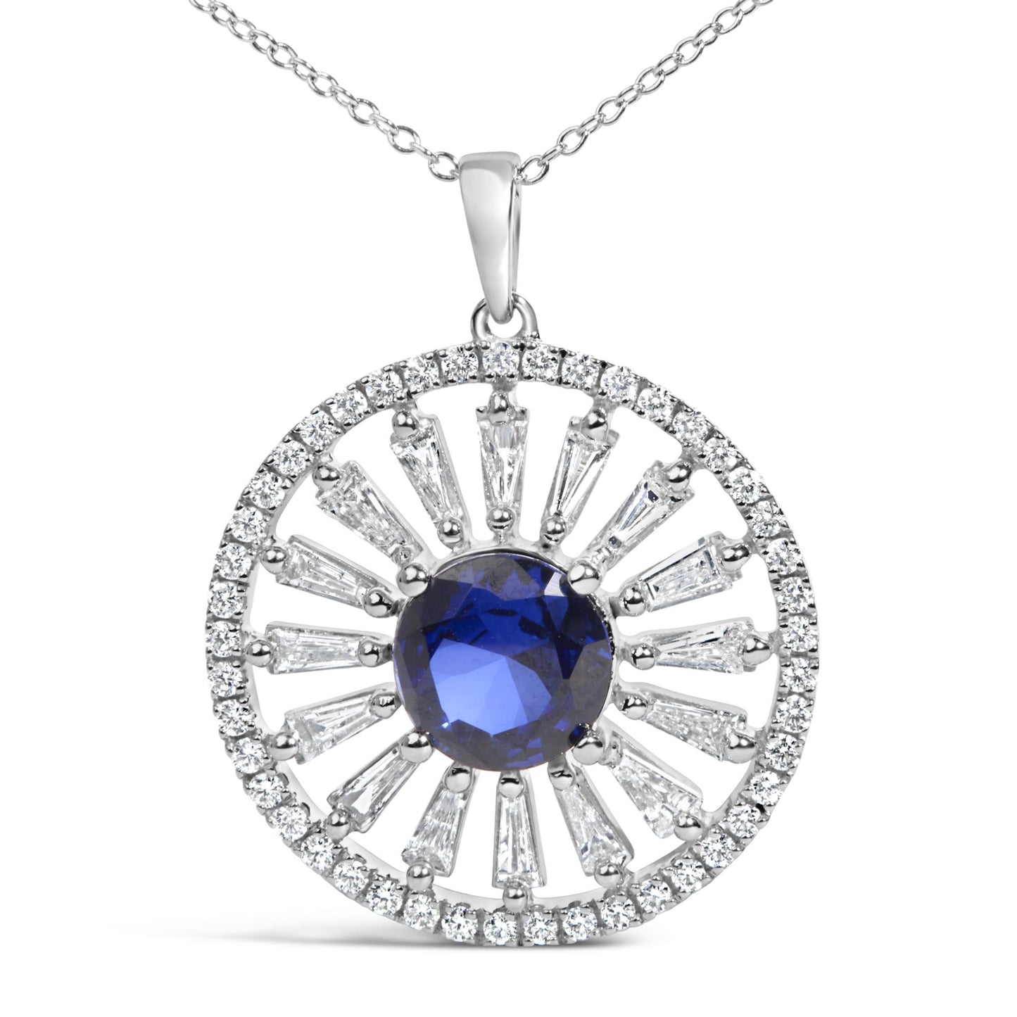 Close-up front view of a white metal necklace pendant featuring a central round blue gemstone surrounded by radiant baguette and round white gemstones in prong settings.